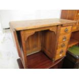 Early 20th Century child's elm single pedestal desk with drop flap, 34.5ins wide x 17ins deep x 25.