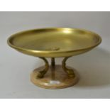 Brass tazza with dolphin supports and a marble base, 15ins diameter