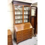 George III mahogany and satinwood crossbanded bureau bookcase, the moulded dentil cornice above a