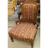 Victorian walnut and inlaid low seat nursing chair on turned front supports