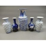Pair of Chinese blue prunus blossom vases, together with another pair of blue and white vases and