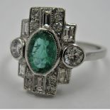 Platinum Art Deco style ring set with central oval emerald surrounded by diamonds, size P