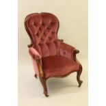 Victorian mahogany spoon back armchair with button upholstered back and seat, carved scroll arms and