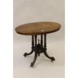 Victorian oval figured walnut occasional table on four turned supports with carved splay feet, 33ins