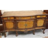 Gillows of Lancaster, mid 20th Century figured walnut semi bow front sideboard, the carved moulded