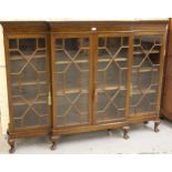 Early 20th Century mahogany dwarf bookcase with four astragal glazed doors on low cabriole supports,