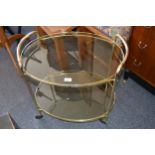 1970's Oval brass and smoke glass two tier drinks trolley