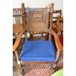 Early 20th Century walnut open armchair in Carolean style with a cane back and seat on barley