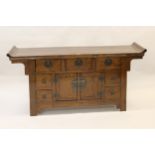 Chinese hardwood side cabinet with three drawers above cupboard doors flanked by short drawers,