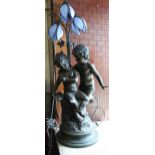 Large bronzed composition floor lamp in the form of two children beneath stylised floral design blue