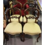 Set of four Victorian carved walnut balloon back dining chairs on cabriole supports