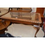Carved mahogany rectangular occasional table with a glass and cane inset top, together with a