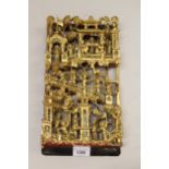20th Century Chinese carved and gilded deep relief wall plaque in the form of figures on terraces,