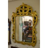18th Century Irish carved and gilded wall mirror, the floral surmount above a rectangular plate with