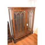 Early 20th Century walnut and inlaid two door display cabinet on low cabriole claw and ball