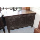 17th Century oak coffer, the hinged lid above a three panel front, raised on stile feet (some