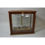 Early to mid 20th Century brass scientific balance scale with a quantity of weights by F.E. Becker &