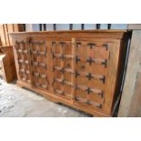 Modern oriental hardwood and iron mounted side cabinet with two pairs of panelled doors on bracket