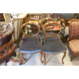 Set of four Victorian walnut balloon back dining chairs on cabriole front supports