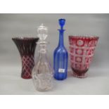 Two red overlay clear glass vases, together with a cut glass decanter and stopper and a blue glass