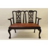 Early 20th Century mahogany carved splat back two seat open arm sofa with drop-in leatherette