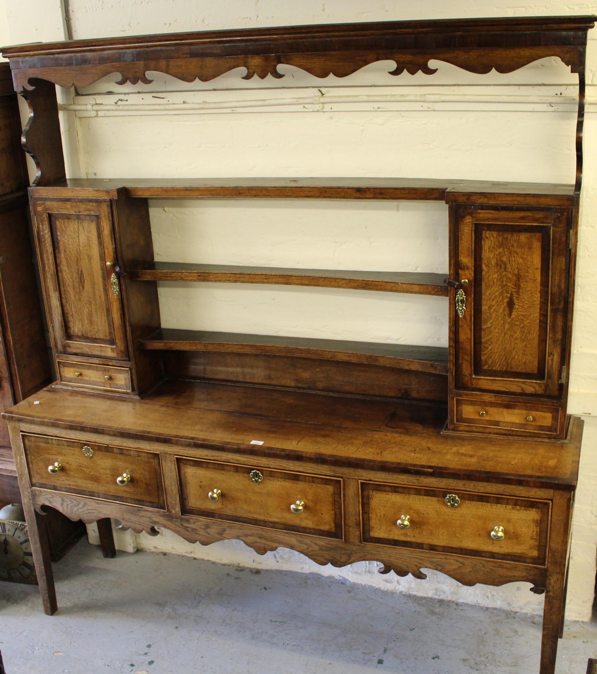 George III oak and mahogany crossbanded dresser, the shelf back with two cupboard doors above