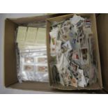 Box containing a collection of various cigarette cards, loose and in sleeves
