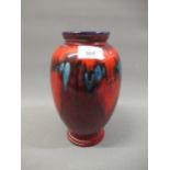 Poole Pottery baluster form vase with abstract decoration on red lustre ground, 9ins high