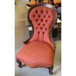 Victorian carved walnut button upholstered low seat nursing chair on cabriole front supports