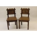 Pair of late 19th Century Gothic style hall chairs with panel backs and seats, raised on chamfered