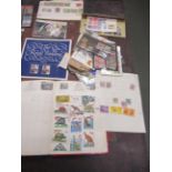 A collection of world stamps housed in four albums together with a quantity of stamps in folders and