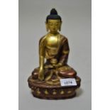 Tibetan gilt patinated seated Buddhistic figure, 8.25ins high