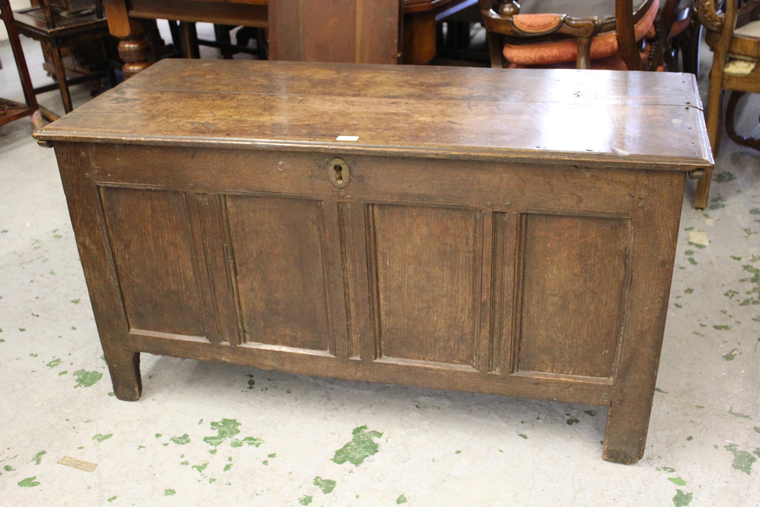 Early 18th Century oak coffer, the moulded plank top above a four panel front raised on stile