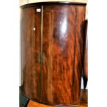 George III mahogany bow fronted two door hanging corner cabinet, 26ins wide together with a