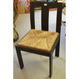 Arts & Crafts oak side chair with a plain splat back above a drop in rush seat, on plain rectangular