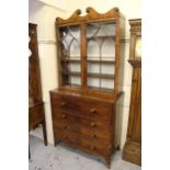 Regency mahogany secretaire bookcase, the shaped cornice above a pair of bar glazed doors