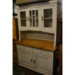 Late 19th / early 20th Century Continental pine side cabinet, the canopy top with glazed doors above