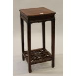 Chinese square hardwood jardiniere stand on square moulded supports with pierced undertier 14.5ins