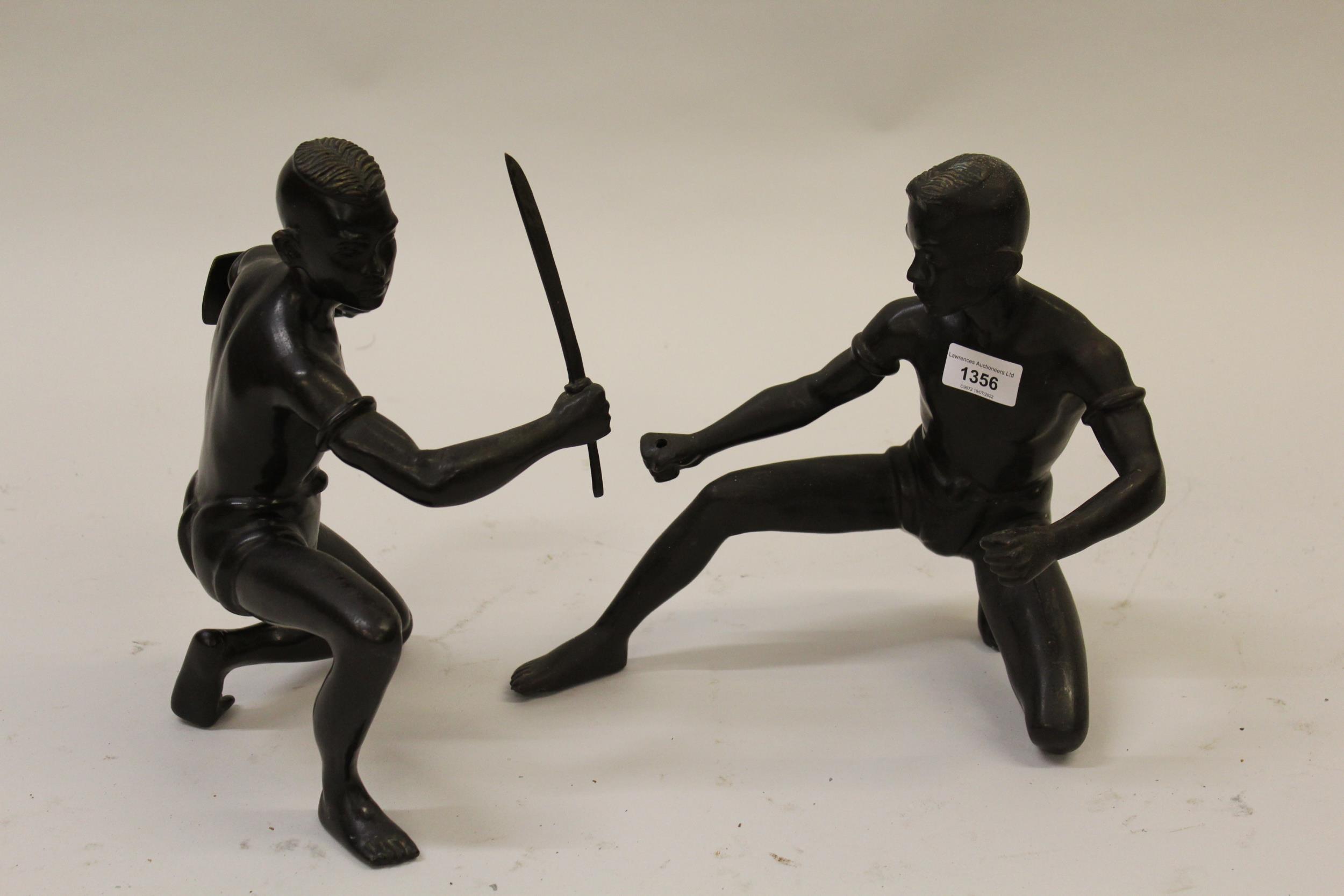 Pair of 20th Century cast bronze figures of Thai swordsmen with dark patinated finish, 11ins and