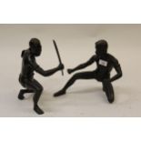 Pair of 20th Century cast bronze figures of Thai swordsmen with dark patinated finish, 11ins and
