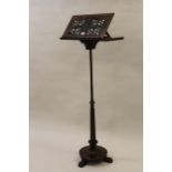 William IV rosewood music stand on turned and octagonal tapering column, circular base and claw feet