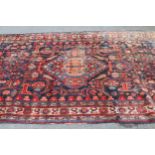 Hamadan rug with a medallion and all-over stylised floral design on a midnight blue ground with