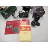 Two Leica camera manuals, together with a Leica brochure, a small Canon G12 digital camera, a Pentax