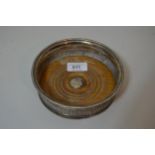 Antique silver bottle coaster with half gadroon wrythen decoration and turned wooden base, bearing
