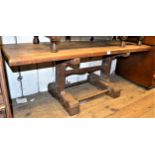 Primitive oak trestle table / bench, the plank top on rectangular cut chamfered supports with shaped