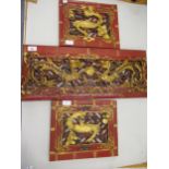 Group of three Chinese red lacquered and gilded wall panels, carved with exotic birds and dragons