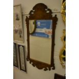 Reproduction walnut Georgian style wall mirror with shaped surmount, 41ins x 22ins