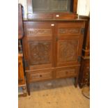 19th Century oak side cabinet with a pair of carved panel doors above two drawers and rectangular