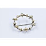 Circular 18ct white gold brooch set seed pearls, 4g