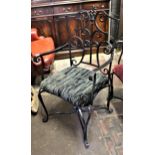 Pair of black painted wrought iron garden elbow chairs
